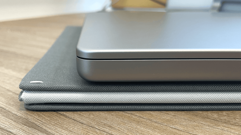 The Levit8 flat folding standing desk folded flat with a closed Macbook Pro 16" sitting on top